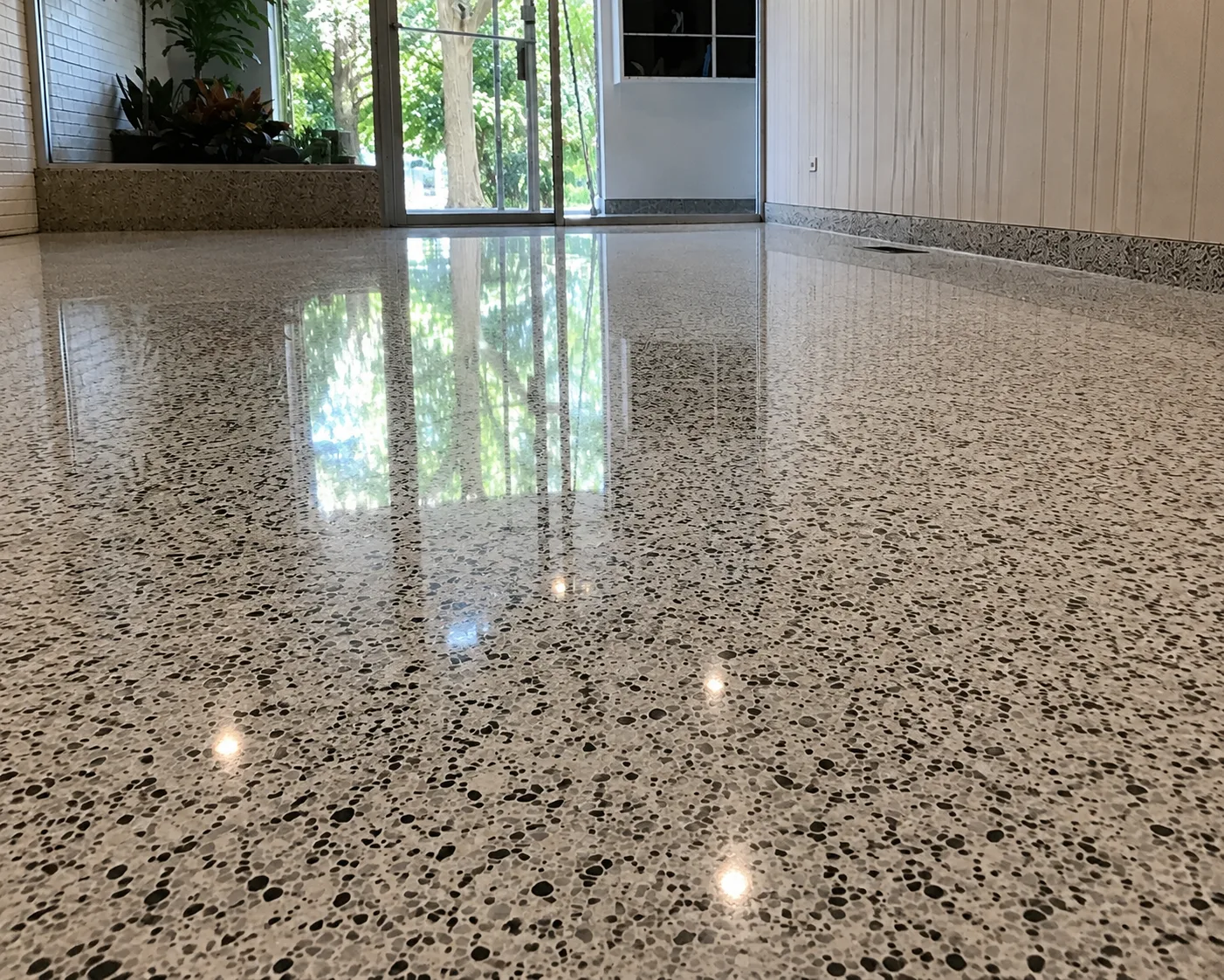 Polished mid-century terrazzo floor with black and gray aggregate in Lincoln Park, Chicago